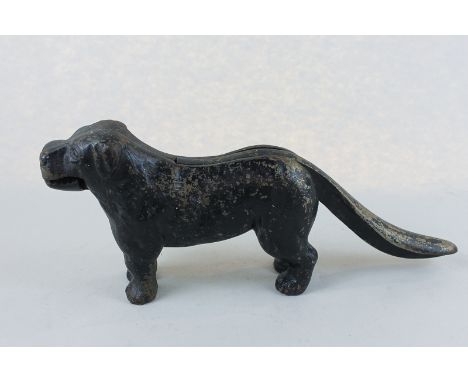 A heavy iron dog nut cracker