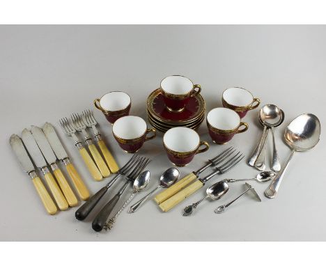 A Wedgwood coffee set in maroon and gilt of six cups and saucers, stamped T Goode Co Ltd, together with a silver jam spoon, s