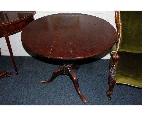 A George III mahogany tea table with circular tilting top on turned column and tripod base, 90cm