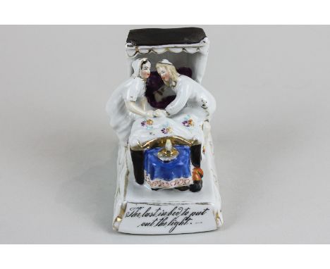 A German porcelain Fairing, 'Last into bed to put out the light'