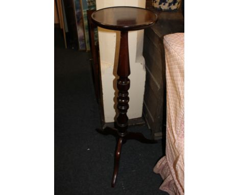 A mahogany torchiere on tripod base, 100cm high