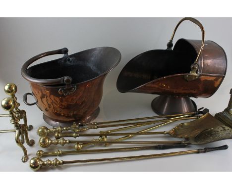 A helmet shaped copper coal scuttle, another coal scuttle, six brass fire tools, a pair of fire dogs and another