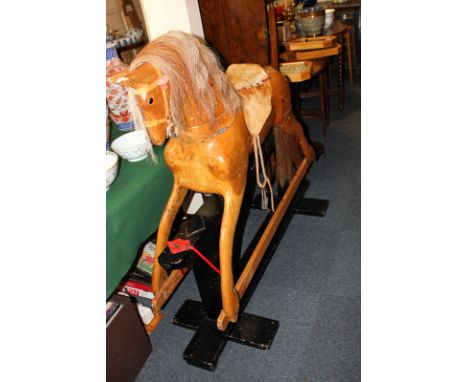 A large wooden rocking horse with made, saddle and tail, on stand, 130cm high 