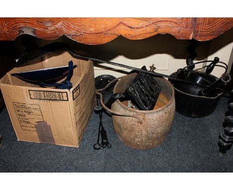 A painted heavy metal saucepan, two heavy metal stew pots, a trivet, kitchen balance scales, a long handled pan and other kit