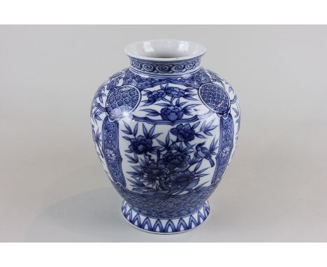 A modern Chinese vase, baluster shape, decorated with panels of flowers, seal mark to base, 21cm