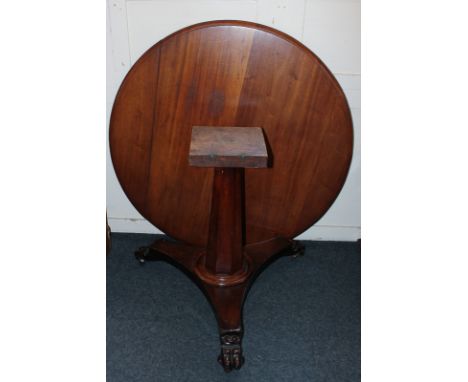 A Victorian circular mahogany table with tilting top on octagonal tapered column and flat tripod base (no fixing bolts)