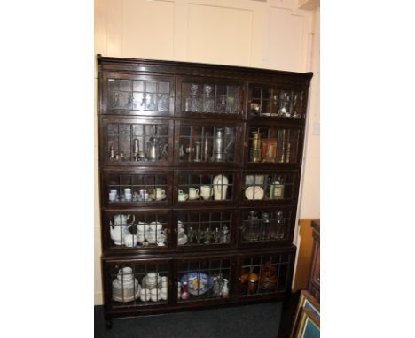 A Minty five tier oak bookcase enclosed by fifteen leaded light glazed doors, 135cm wide by 175cm high 