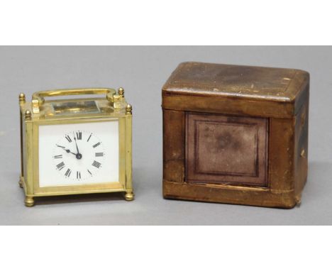 FRENCH BRASS FOUR PANE CARRIAGE CLOCK AND CASE, the enamelled dial on an eight day movement, with key and case, height to fin