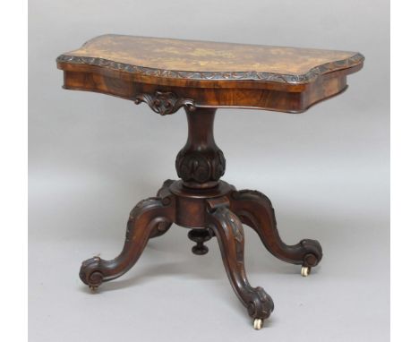 VICTORIAN WALNUT CARD TABLE, the shaped rectangular top with marquetry inlay and carved detailing, on scrolling legs, height 