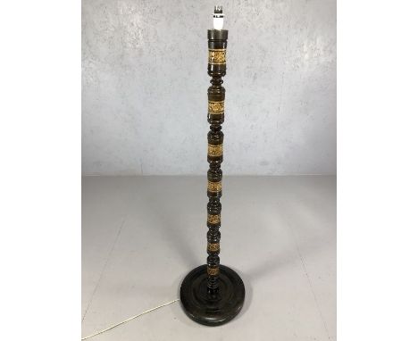 Wooden carved standard lamp of leaf design on circular base