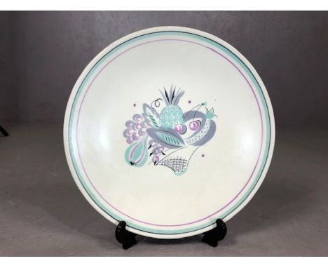 1950's Poole Pottery charger decorated in tones of purple and green. Approx 33cm Diameter.