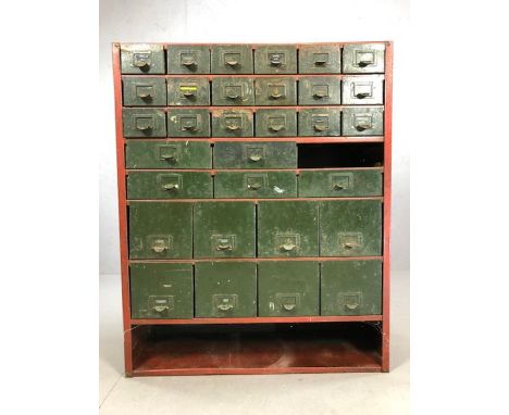 Industrial metal filing cabinet of multiple graduated drawers, with shelf under, in red metal frame (A/F), approx 92cm x 30cm