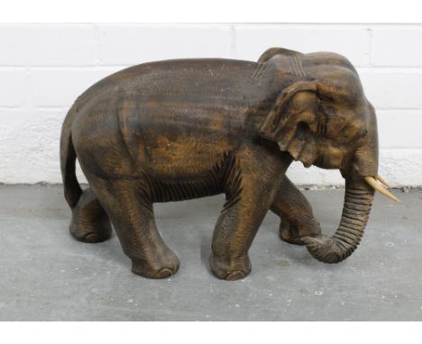 Large carved wooden elephant with light wood tusks simulating ivory, 30 x 50cm 