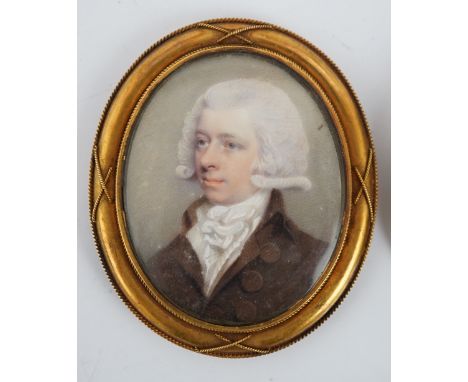 Y English School circa 1800 Portrait miniatures of John and Elizabeth Bromeoil on ivory (2)he wearing a brown coat with white