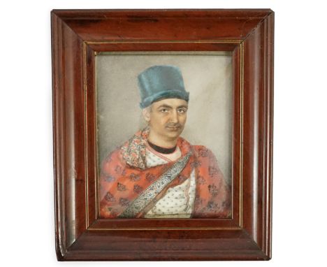 Y 19th Century Indian School Portrait miniature of an Indian gentlemanwatercolour on ivorywearing robes and a blue hat, appar
