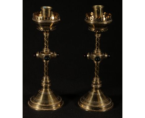 Pair of brass ecclesiastic candlesticks having pierced borders, the knop decorated with four bosses raised on cup base, 26cm 