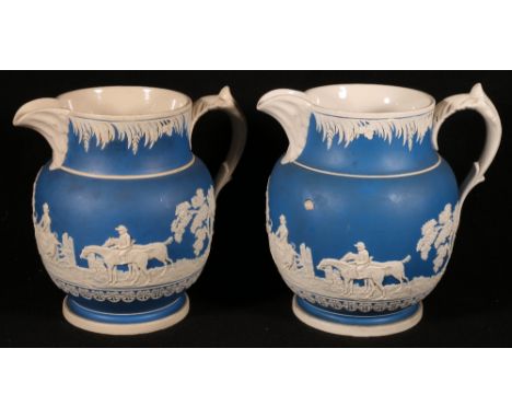 Pair of Copeland Spode Adams style jugs, the blue ground decorated in relief with hunting scenes, 24cm tall