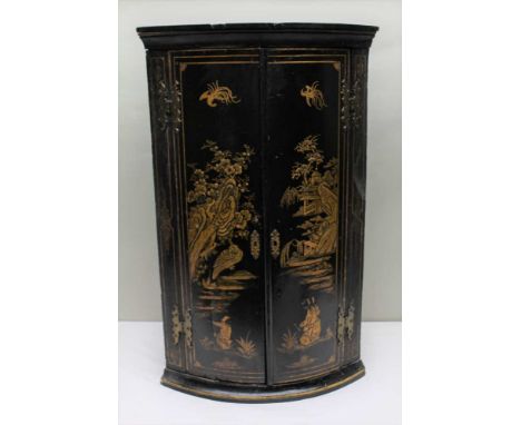 19TH CENTURY CHINOISERIE DECORATED BOW FRONT HANING CORNER CUPBOARD finished in black decorated gilt gesso, having fancy shap