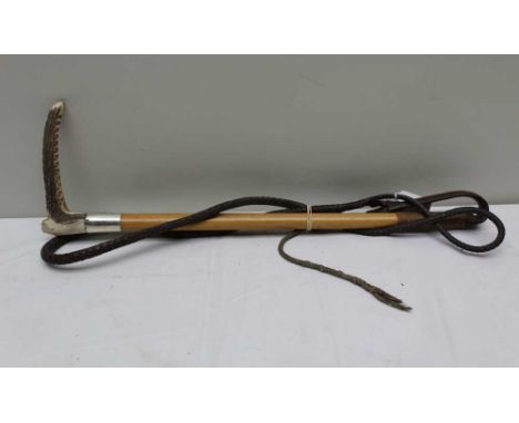 A GENTLEMAN'S HUNTING CROP with antler grip, silver collar, malacca shaft and plaited leather leash 