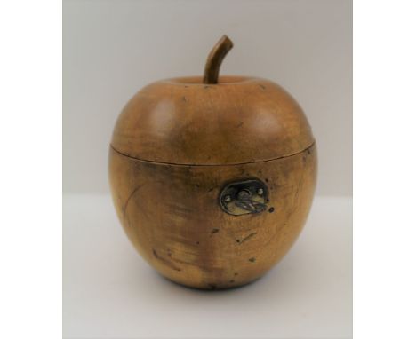 A TREEN FRUITWOOD TEA CADDY IN THE FORM OF AN APPLE, the hinged cover with stalk finial, in the Georgian style, fitted lock w