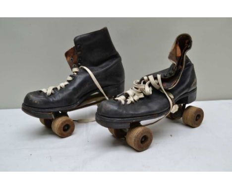 A PAIR OF "HAMACO GATE" VINTAGE ROLLER SKATES, Size 10, laced leather upper with wooden wheels, stamped "Hamaco Tenacity No. 