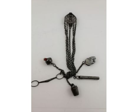 A LATE VICTORIAN / EDWARDIAN BRIGHT STEEL CHATELAINE, the pierced belt clip with five chains suspending; scissors, a pin cush