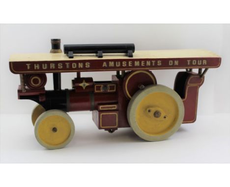 A 20TH CENTURY SCARTCH BUILT PAINTED WOOD SHOWMAN'S TRACTION ENGINE, sign written "Thurstons Amusements on Tour", red and yel