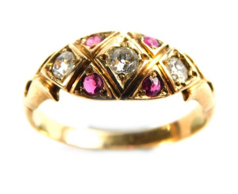 An Edwardian ruby and diamond dress ring, the central marquise shaped panel set with round brilliant cut diamonds and four ru