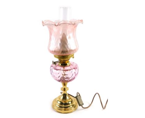 A 20thC oil lamp, with amethyst coloured shade and reservoir,  with brass stem, dials marked duplex, with modern electrical f