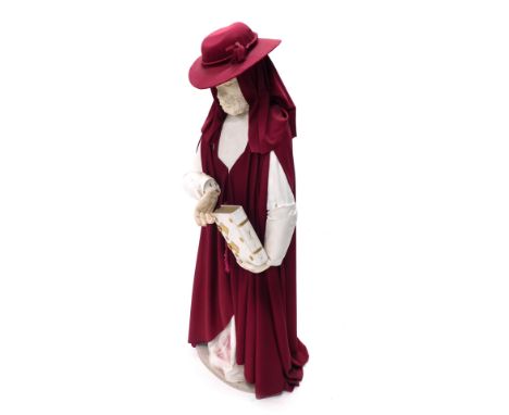 A polystyrene freestanding figure of a clergyman in hat and cloak holding Bible, 113cm high. 