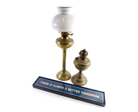 An early 20thC brass oil lamp, with milk class shade on fluted stem, 58cm high, another oil lamp and wall plaque There is Alw