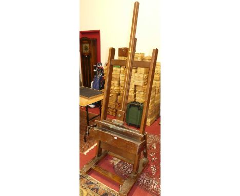 A large stained wood freestanding adjustable artists easel