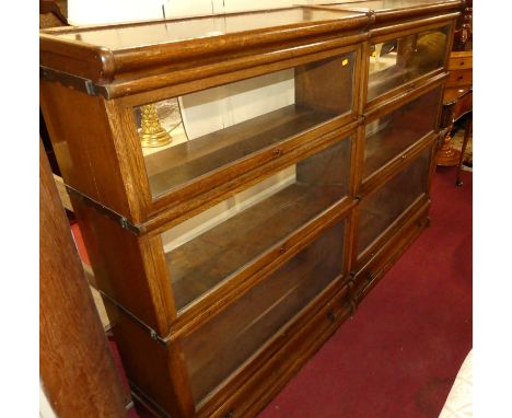 A pair of 1930s oak Globe Wernicke three-tier stacking bookcases, each with single long lower drawer and typical hinged glaze