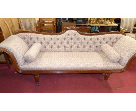 A Regency mahogany scroll-end four-seater sofa, floral button back fabric upholstered, raised on reeded tapering forelegs to 