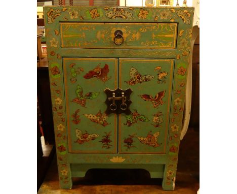 An Eastern painted and gilt decorated double door bedside cupboard, having single upper drawer, decorated with exotic butterf