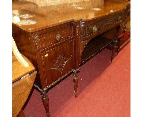 An early 20th century mahogany breakfront sideboard in the Adam taste, having long central frieze drawer over open shelf, fla