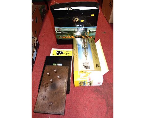 A JCB 50 years of worldwide service site master and farm trailer gift set, housed in the original card sleeve with display pl