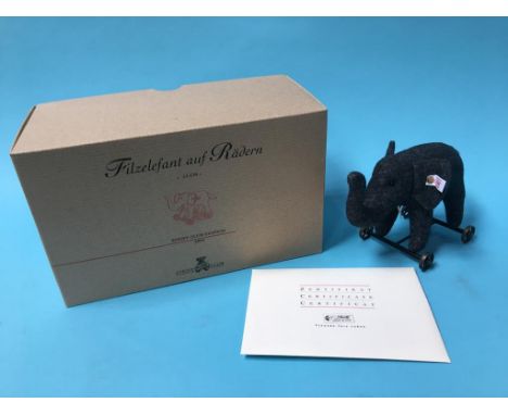 A Steiff felt elephant on wheels, with box and certificate