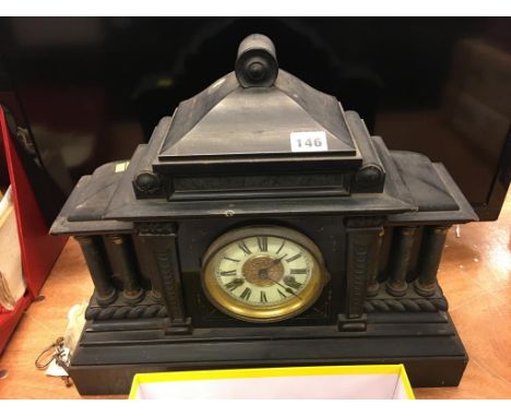 An ebonised mantle clock