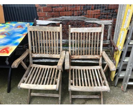 A pair of garden chairs and a bench