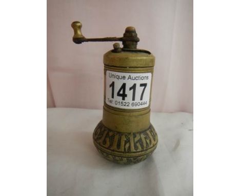 An early 20th century brass pepper grinder,