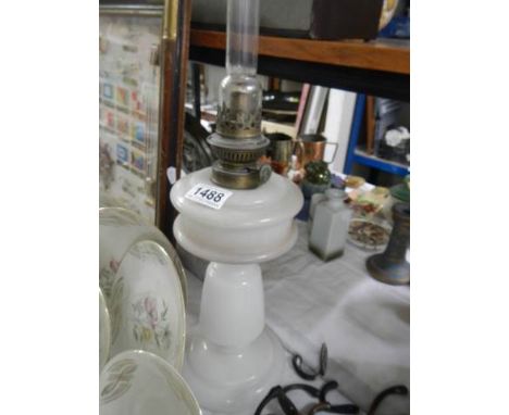 An early 20th century glass oil lamp.