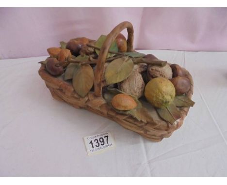 A ceramic fruit basket (chips to ends of two leaves).