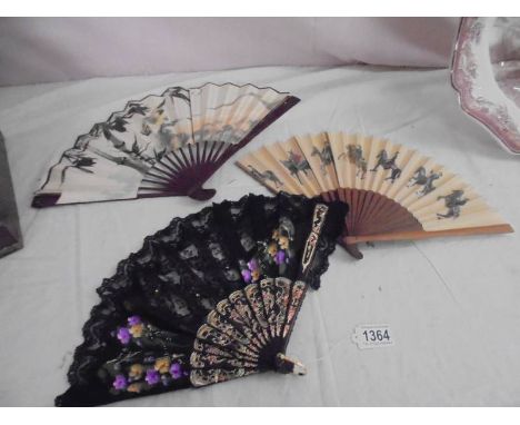 A nice black lace fan and two others.