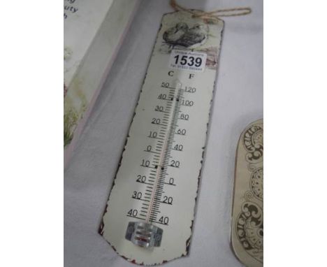 An enamel kitchen thermometer.