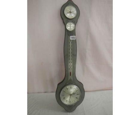 A barometer with silver coloured dial.
