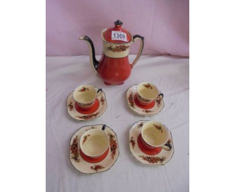 A Wedgwood 'Richelieu' pattern coffee pot with four coffee cups and saucers.