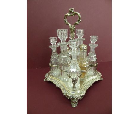 Victorian silver eight bottle cruet with shaped border on four splayed feet. One silver topped original bottle - Sheffield 18