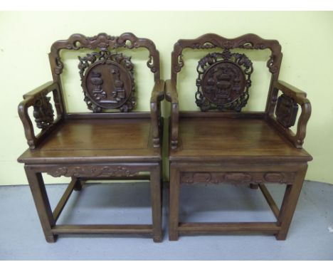 A set of five Chinese carved hardwood ceremonial thrones with shaped tops, circular panel and flat backs, solid seats, square