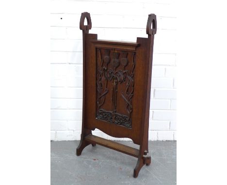 An Arts &amp; Crafts oak screen, probably Scottish, carved with three thistles and celtic knotwork pattern, 48 x 84cm.